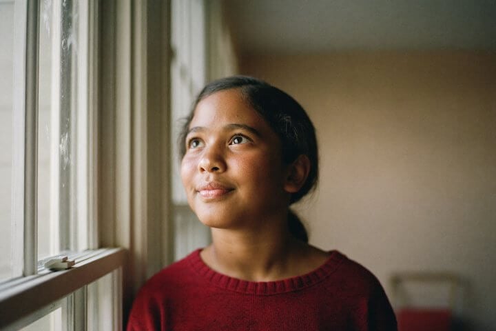 A Grade 5 student looking out of a window