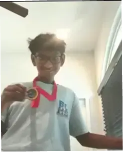 Tarun with his medal for the county-level coding competition.